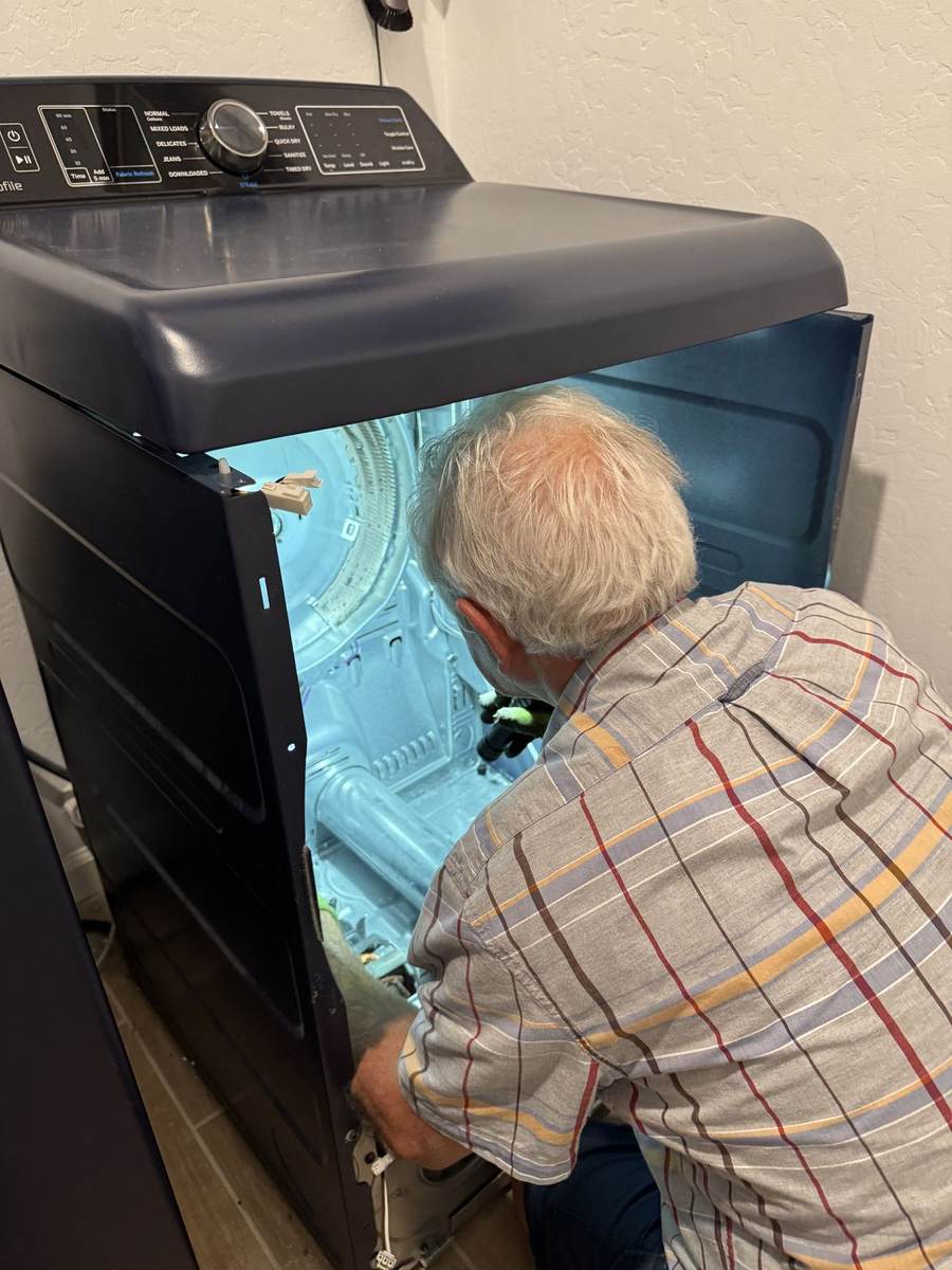 MVI technician inspecting a dryer drum interior during a maintenance visit
