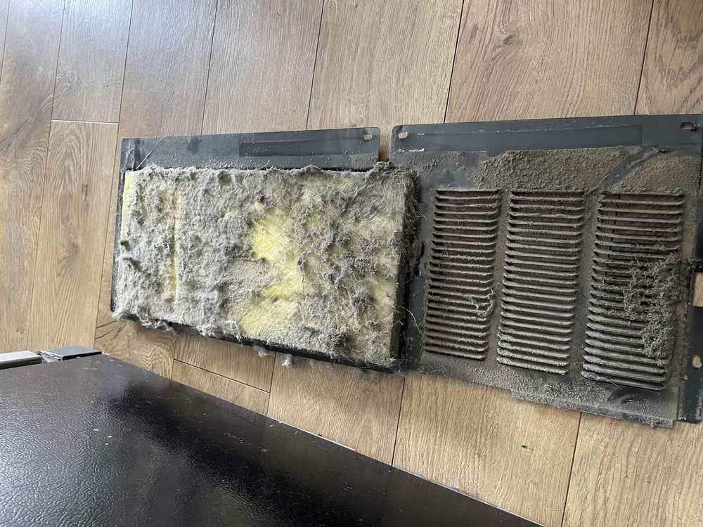 Dryer vent panel clogged with lint and dust before cleaning